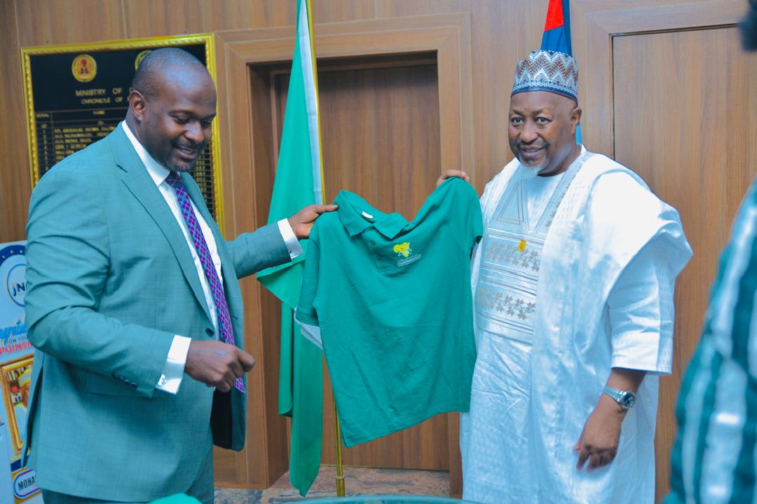 The minister of Defence Federal Republic of Nigeria receiving AAYC Souvenir from the Secretary General