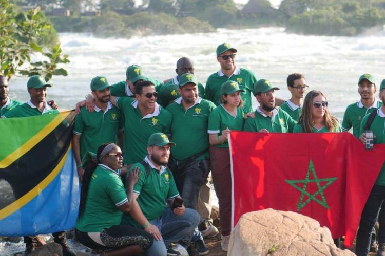 AAYC Delegates posing in a picture a Busoowoko Falls holding flags from their different nationalities