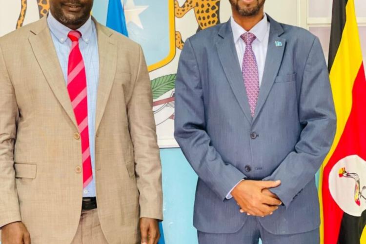 Secretary General having a photo moment with Deputy Ambassador of Somalia to Uganda HE Mr. Abdilatif Somali at the Embassy